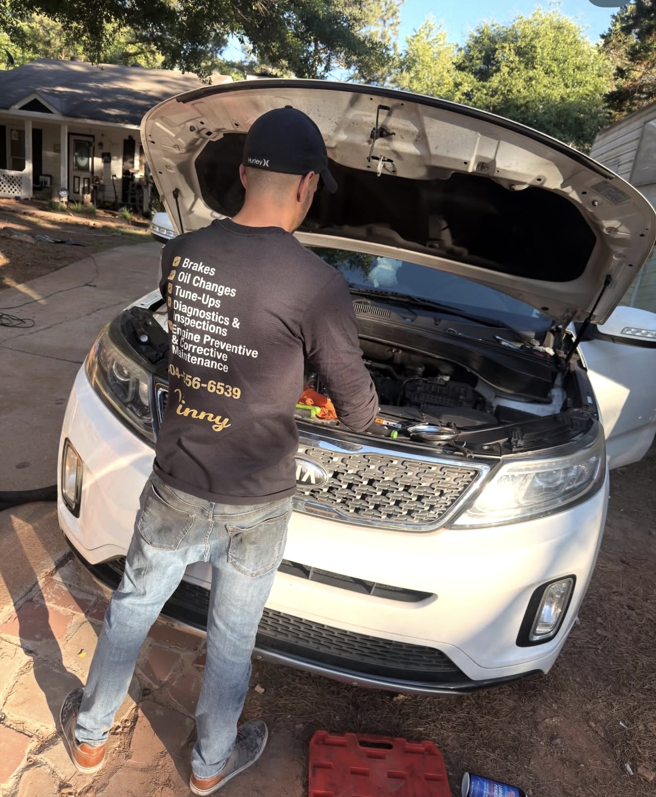 Vinny’s hands working on a vehicle