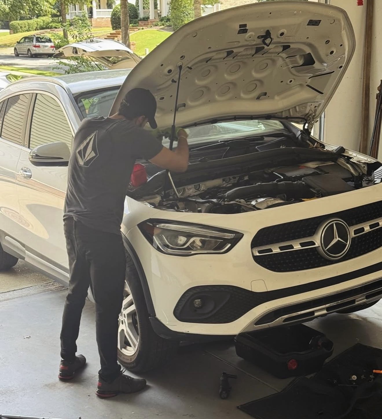 Vinny’s hands working on a vehicle